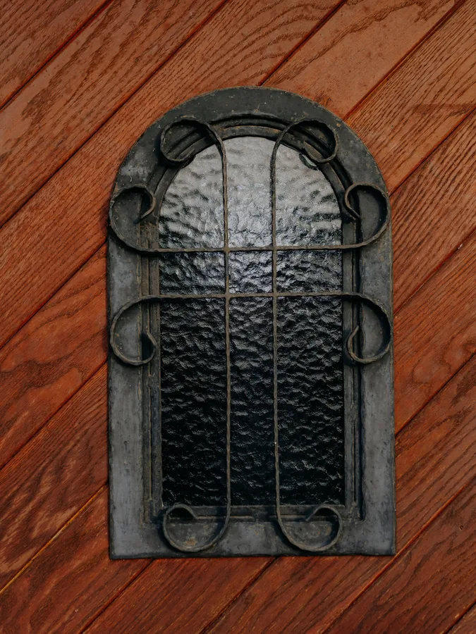 Iron Window on Red Wood