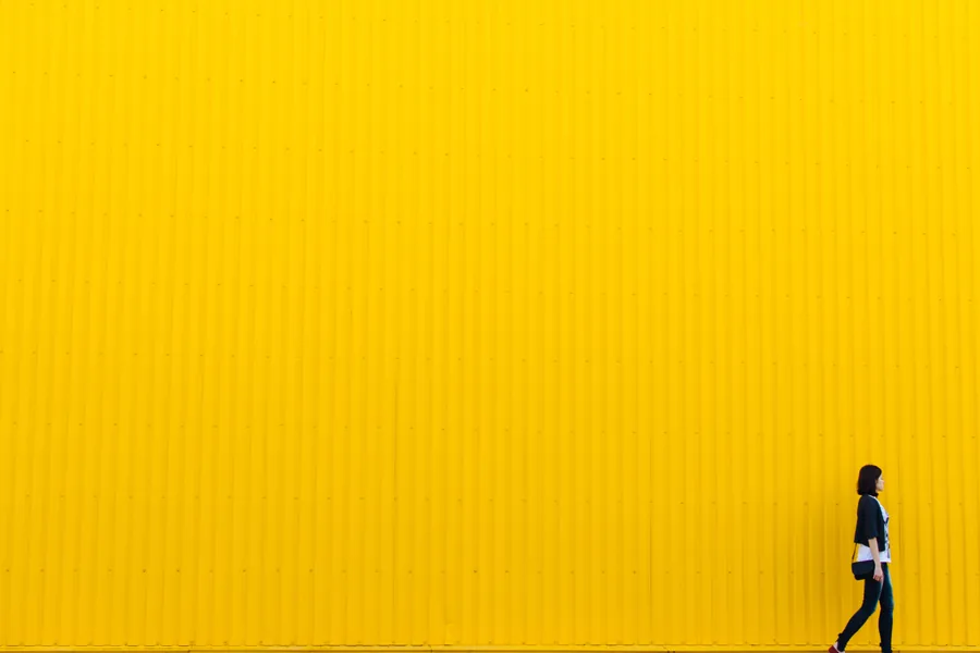 Walking Past a Yellow Wall